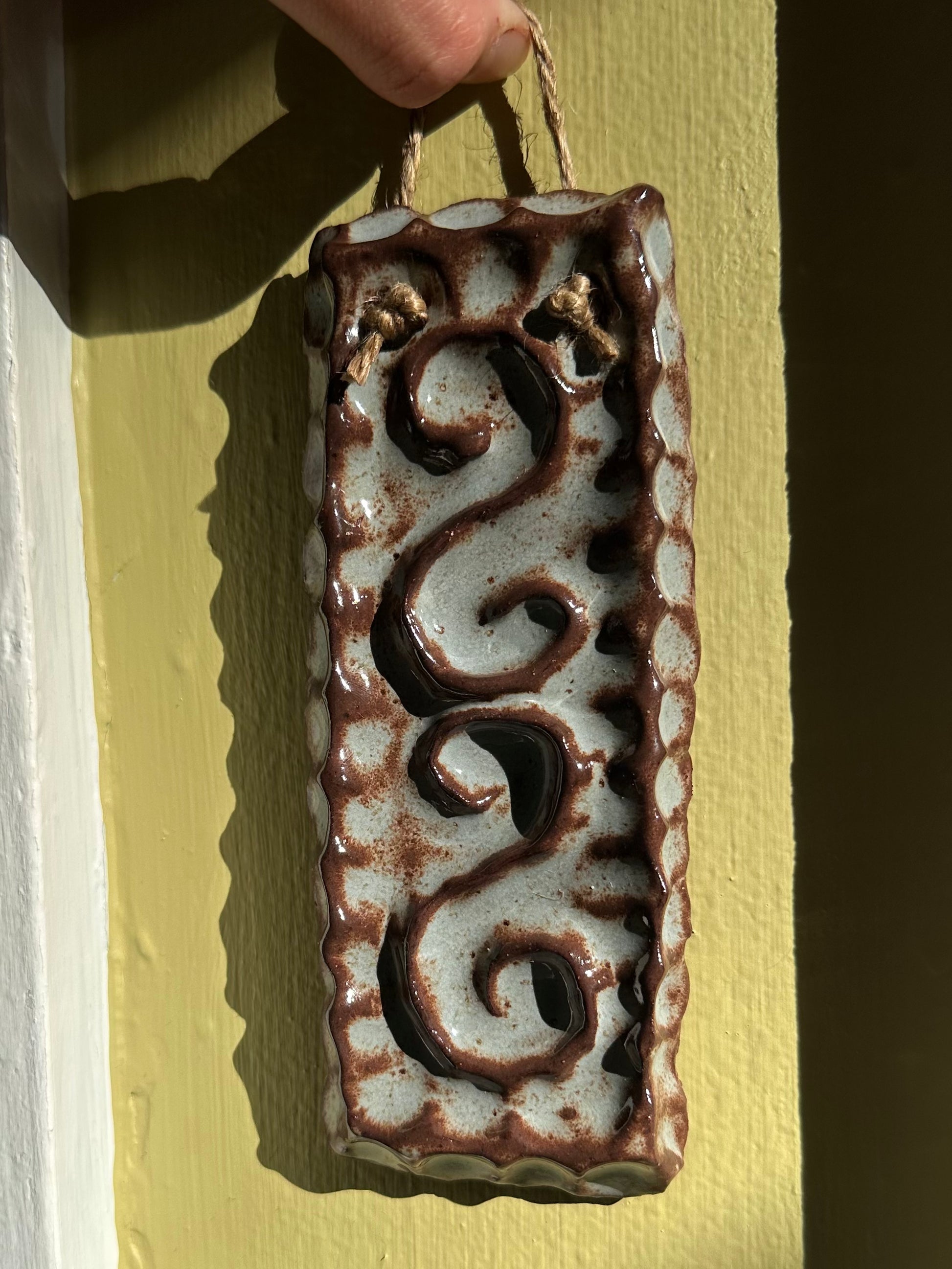 Ceramic blue and brown textured wall hanging.